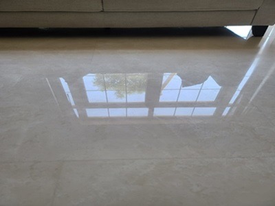 The same marble floor bright and reflective after polishing