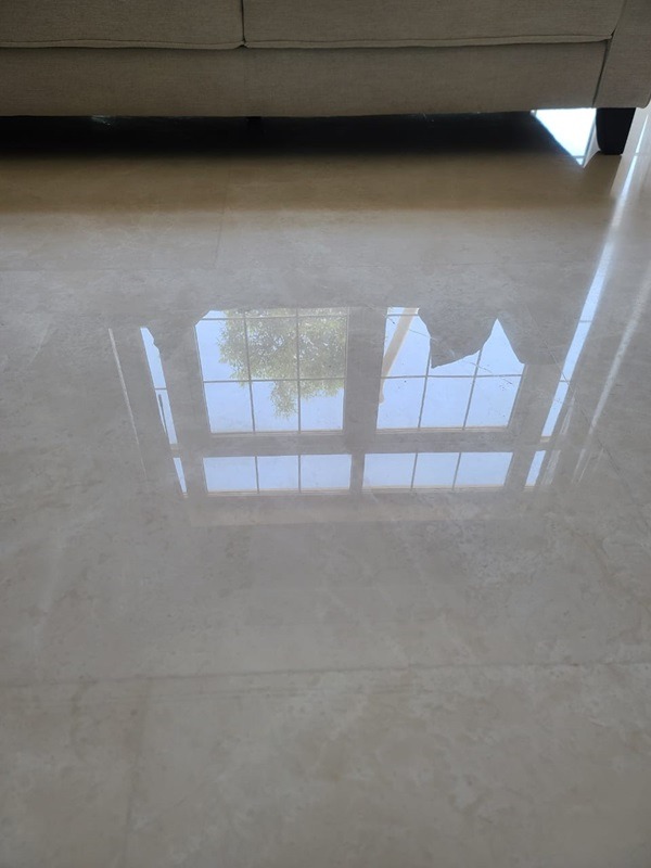 The same living-area floor with a clear reflection after restoration